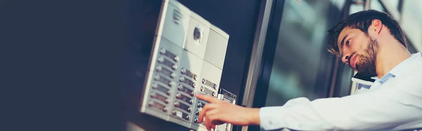 Hand entering code on security access panel